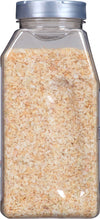 A clear plastic container filled with dried minced onions.