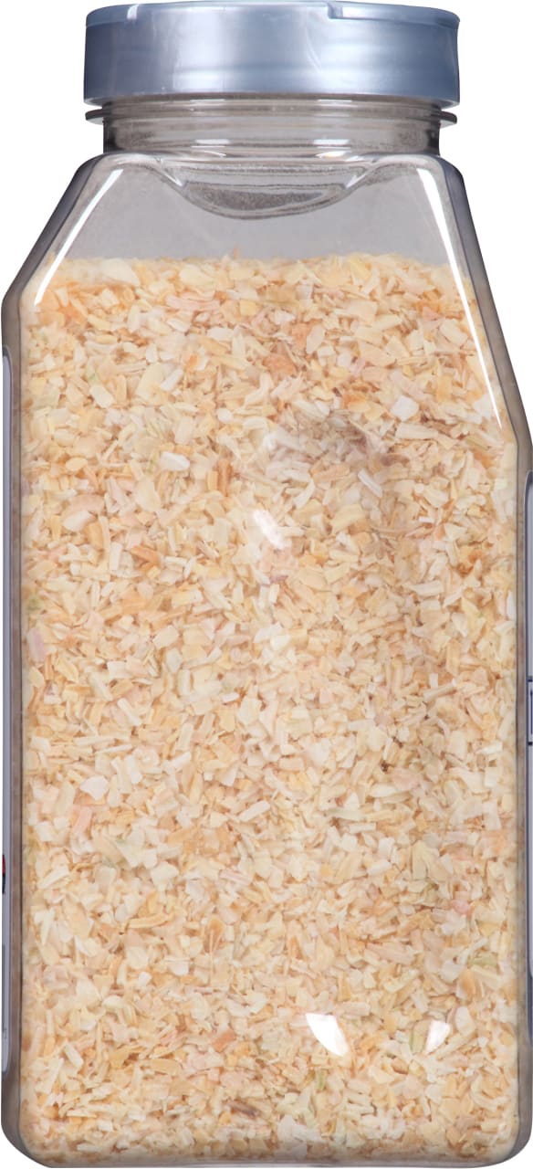 A clear plastic container filled with dried minced onions.