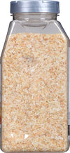 A clear plastic jar filled with dried minced onions.