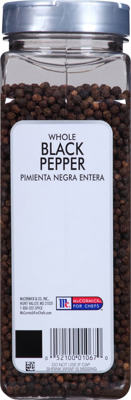 A container of McCormick For Chefs Whole Black Pepper.