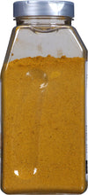 A glass jar filled with yellow curry powder.