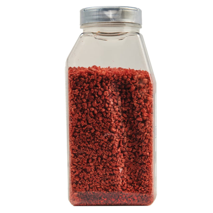 A glass jar filled with red sprinkles.