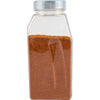 A clear plastic spice container filled with a reddish-brown spice.