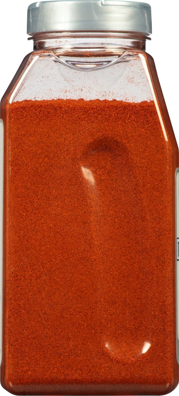 A clear plastic jar filled with red paprika.