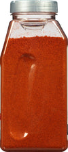 A clear plastic jar filled with red paprika.