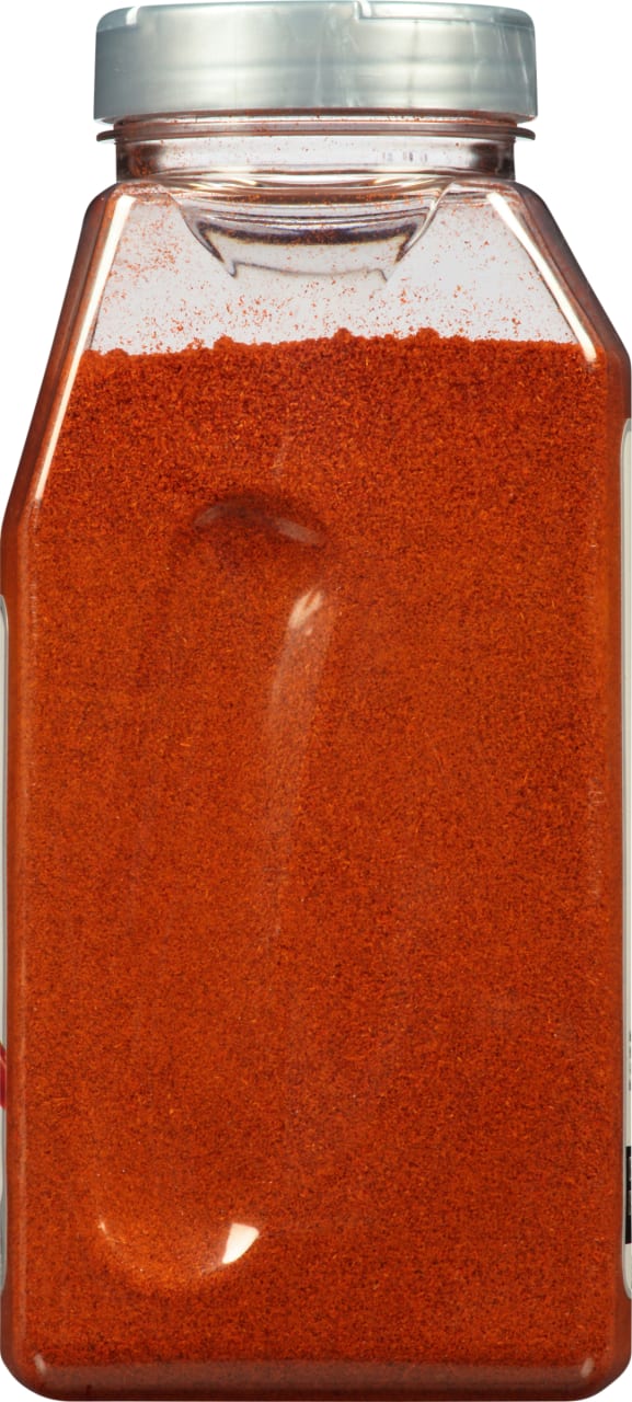 A clear plastic jar filled with red paprika.