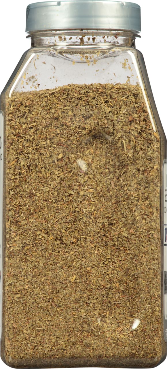 A clear plastic jar filled with dried herbs.