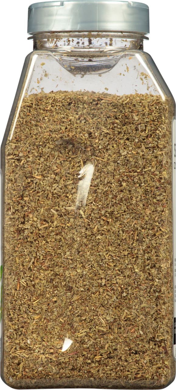 A clear plastic jar filled with dried herbs.