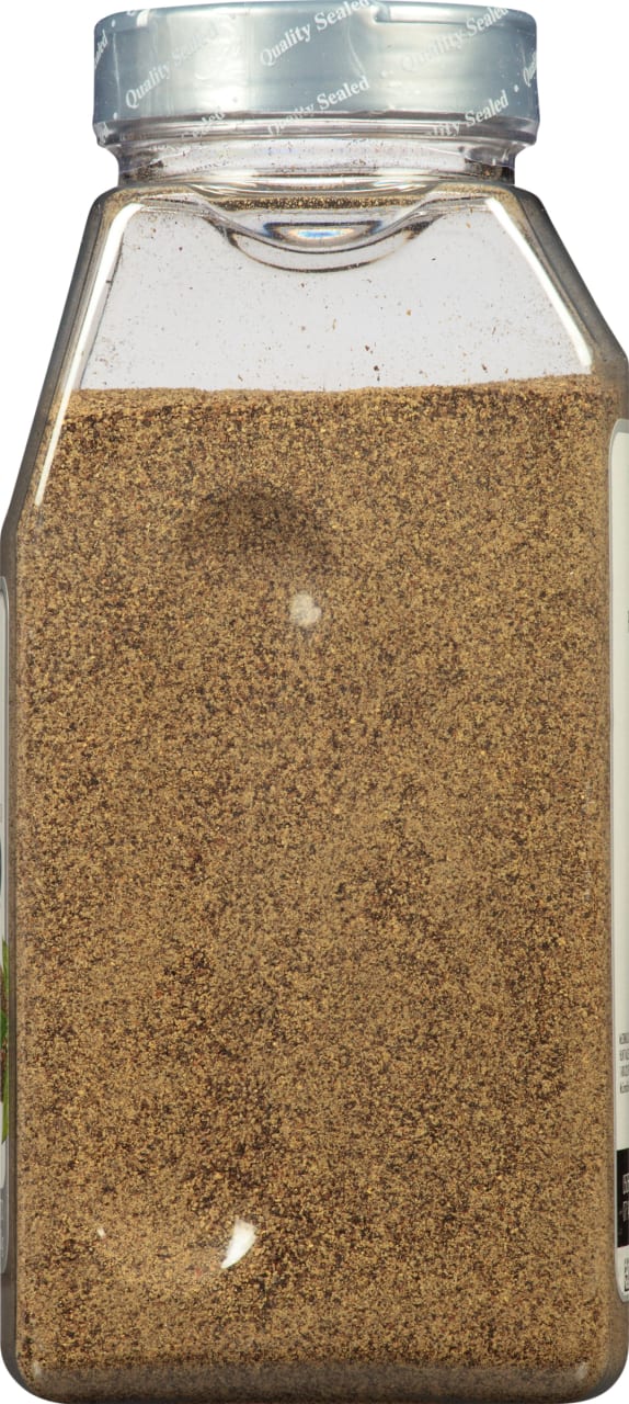 A glass jar of ground black pepper.