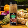 A jar of McCormick Grill Mates Montreal Chicken Seasoning next to grilled chicken and asparagus.
