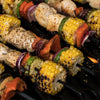 Grilled chicken and vegetables on skewers.