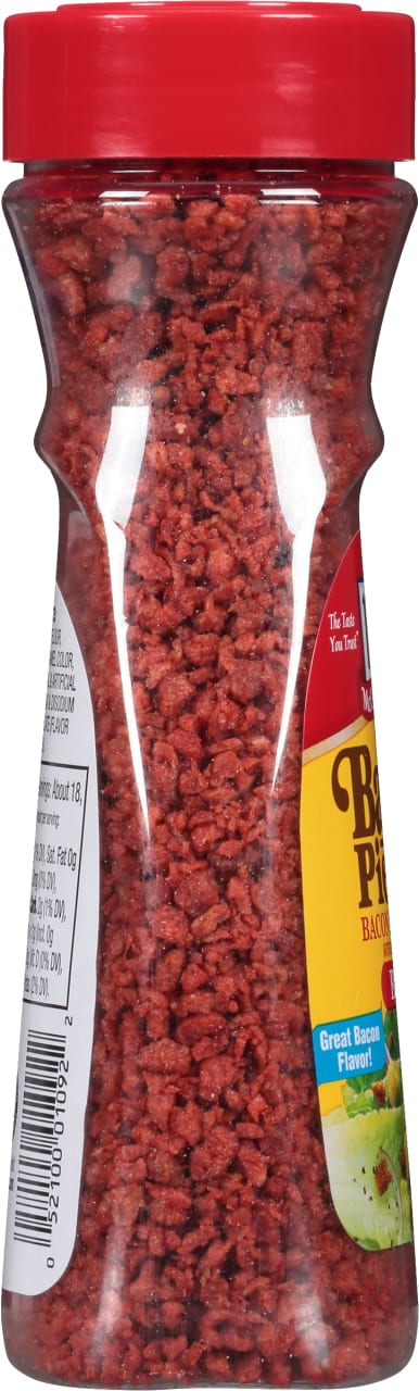 A jar of McCormick Bacon Pieces with a red lid.