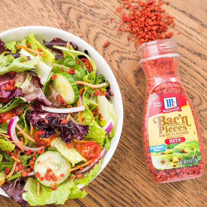A bowl of salad with McCormick Bac'n Pieces sprinkled on top.