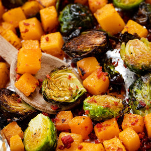 Roasted butternut squash and brussels sprouts with bacon bits.