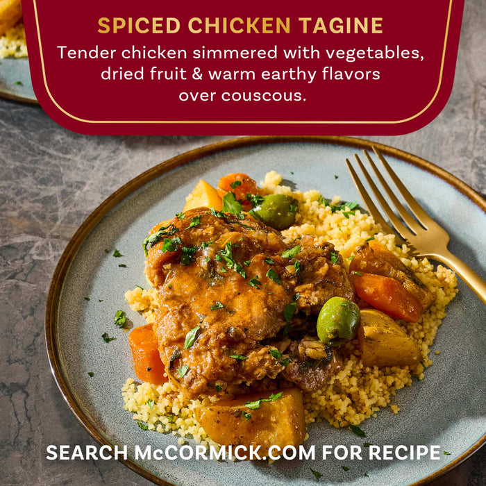 A plate of McCormick's Spiced Chicken Tagine with vegetables, dried fruit, and couscous.