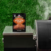A packet of McCormick Grill Mates Brown Sugar Bourbon seasoning sits on a grill.