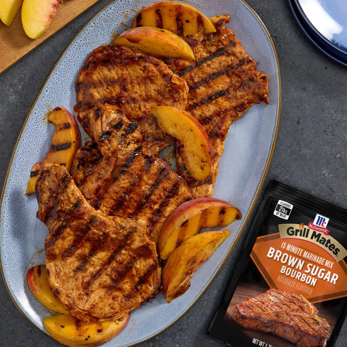 Grilled pork chops with peach slices, seasoned with a packet of Greg &amp; Wiley Brown Sugar Rub.