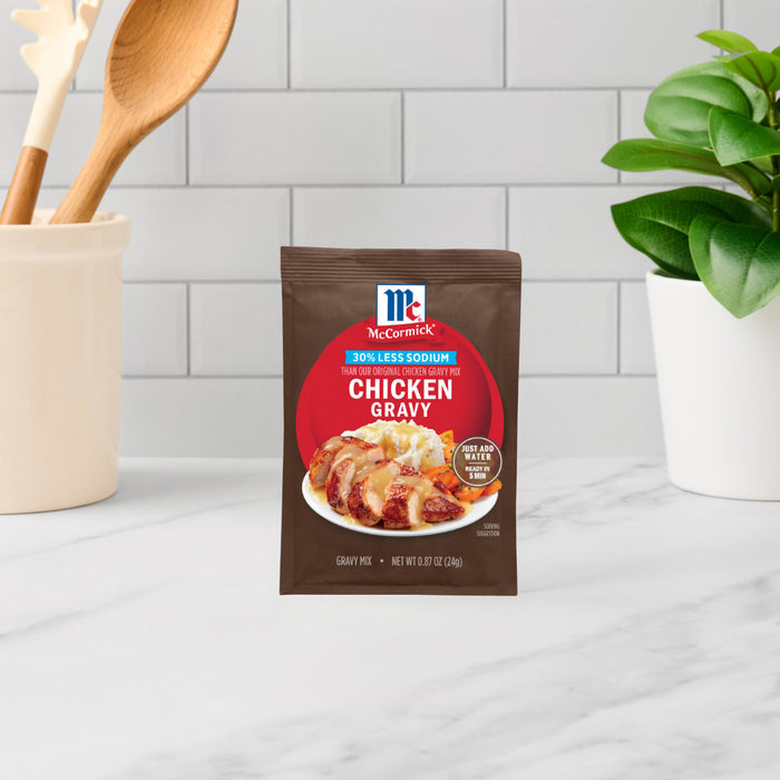 A packet of McCormick Chicken Gravy mix sits on a countertop.