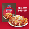 McCormick 30% Less Sodium Chicken Gravy mix is shown with a prepared dish of sliced chicken, mashed potatoes, and carrots.