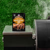 A packet of McCormick Slow Cookers Memphis Pit BBQ seasoning mix sits on a grill.