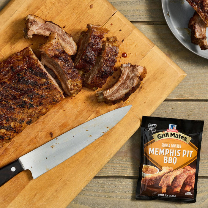 A package of McCormick Memphis BBQ Rub is displayed next to a cutting board with sliced ribs.