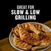 Grilled chicken legs on a plate, advertised as great for slow and low grilling.