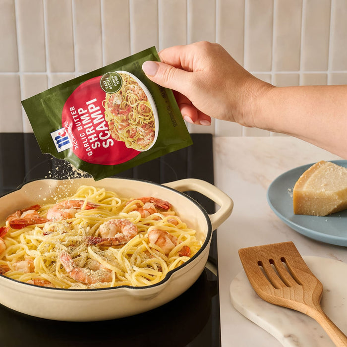 A sheet pan filled with roasted broccoli, cherry tomatoes, and shrimp prepared using Mccormick Garlic Butter Shrimp Scampi Seasoning Mix .87 Oz for a quick 20-minute meal.