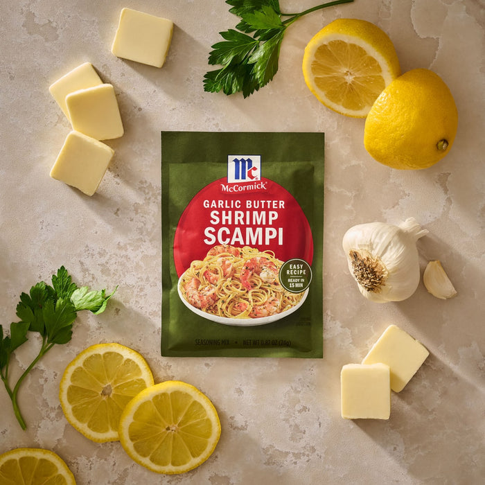 A bowl of pasta topped with shrimp and herbs prepared using Mccormick Garlic Butter Shrimp Scampi Seasoning Mix .87 Oz as a rich and buttery 15 minute meal.