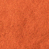A close-up texture of vibrant orange-red chili powder.