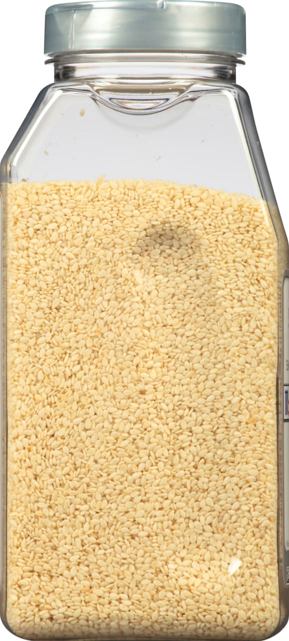 A clear plastic jar filled with sesame seeds.