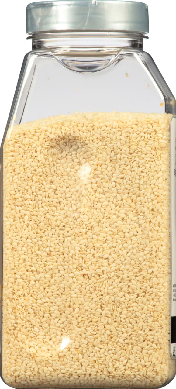 A clear jar filled with white sesame seeds.