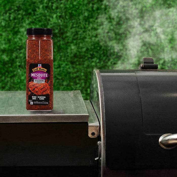 A jar of Pit Boss Smoked Chili Flakes sits next to a grill, suggesting its use in outdoor cooking.