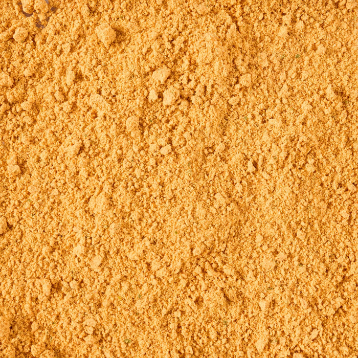 A close-up of a pile of vibrant golden-yellow powder.
