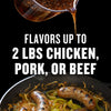 A flavorful sauce is poured over sausages and peppers in a cast iron skillet with text stating it flavors up to 2 lbs of chicken pork or beef.