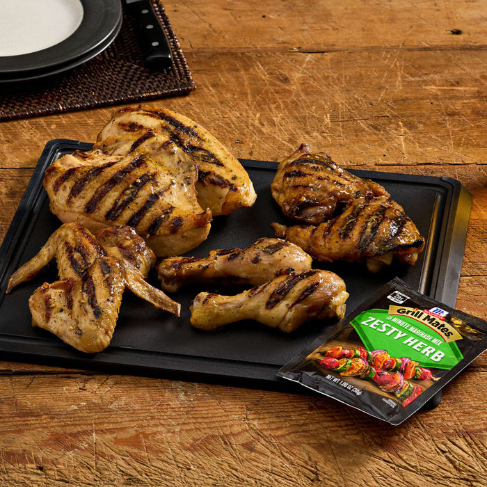 A platter of grilled chicken pieces, including wings, drumsticks, and breast, is displayed with a packet of Jack Link's jerky.