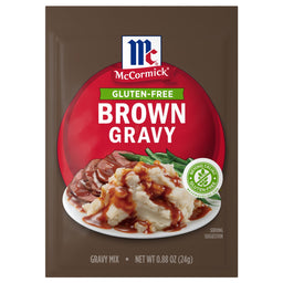 A package of Mccormick Brown Gravy Mix .88 Oz featuring a serving suggestion of gravy poured over mashed potatoes and sliced beef with green beans.