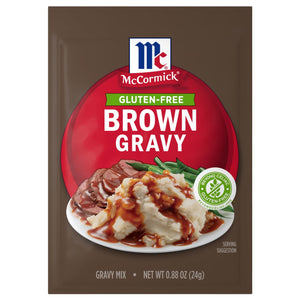 A package of Mccormick Brown Gravy Mix .88 Oz featuring a serving suggestion of gravy poured over mashed potatoes and sliced beef with green beans.