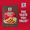 McCormick Turkey Gravy packet featuring a serving suggestion of sliced turkey with gravy, stuffing, and cranberries, emphasizing the brand's trusted taste.
