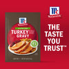 McCormick Turkey Gravy packet featuring a serving suggestion of sliced turkey with gravy, stuffing, and cranberries, emphasizing the brand's trusted taste.