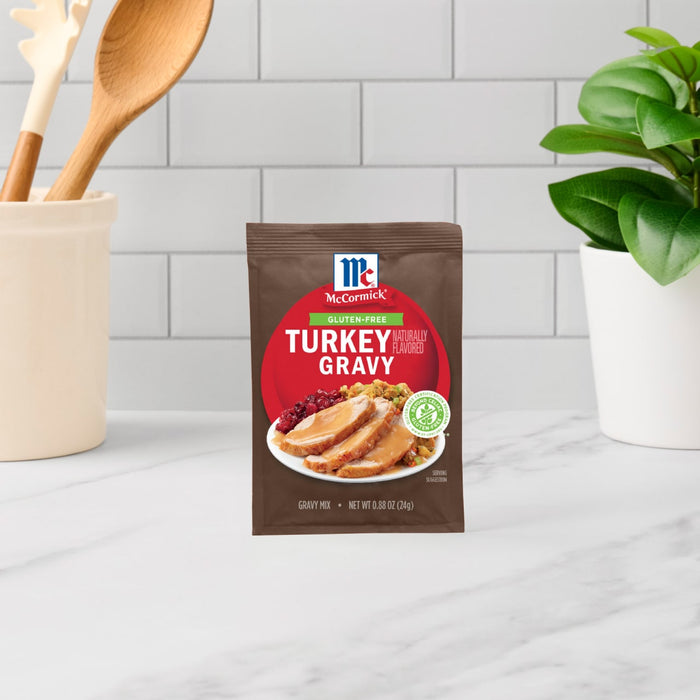 A packet of McCormick Turkey Gravy mix sits on a counter.