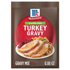 A package of Mccormick Turkey Gravy Gluten Free mix, featuring a plate of sliced turkey with gravy, cranberry sauce, and stuffing.