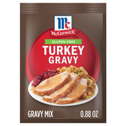 A package of Mccormick Turkey Gravy Gluten Free mix, featuring a plate of sliced turkey with gravy, cranberry sauce, and stuffing.