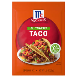 A package of Mccormick Regular Taco Seasoning Mix 1.25 Oz featuring a gluten-free label and a serving suggestion of two beef tacos topped with tomatoes and cheese.