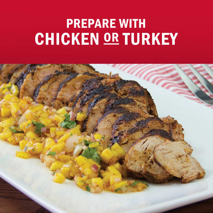 A plate of sliced grilled chicken or turkey served with a vibrant mango salsa.