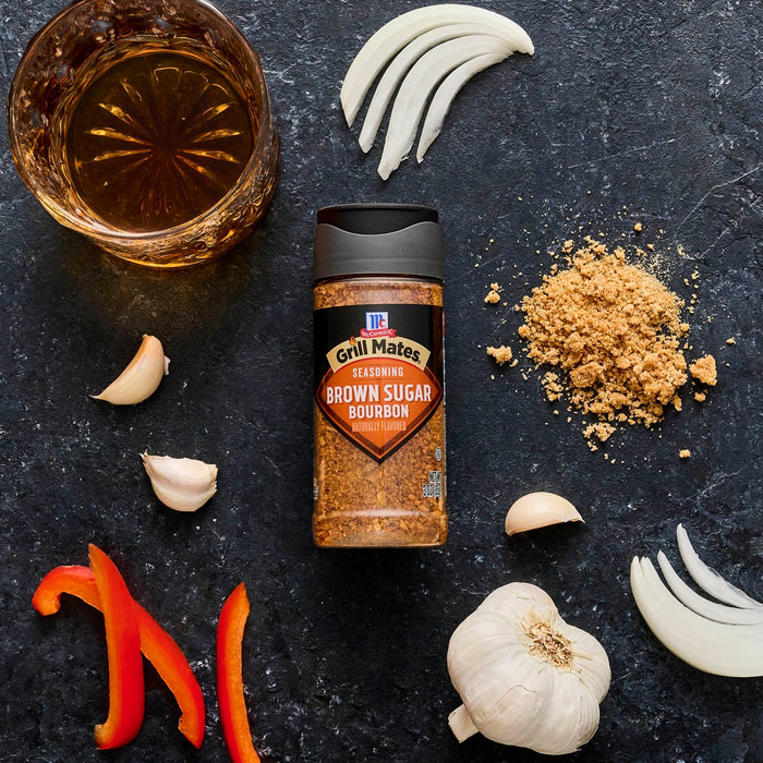 McCormick's Slow Cookers Brown Gravy seasoning mix is displayed with ingredients like garlic, onion, red pepper, brown sugar, and a glass of whiskey.
