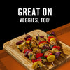 Colorful chicken and vegetable skewers, seasoned with Mccormick Grill Mates Brown Sugar Bourbon Blend Gf 3.0 Oz, are displayed on a wooden board, emphasizing its versatility with the text GREAT ON VEGGIES, TOO!