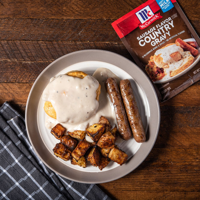 McCormick Sausage Flavor Country Gravy mix with a plate of sausage biscuits and gravy.