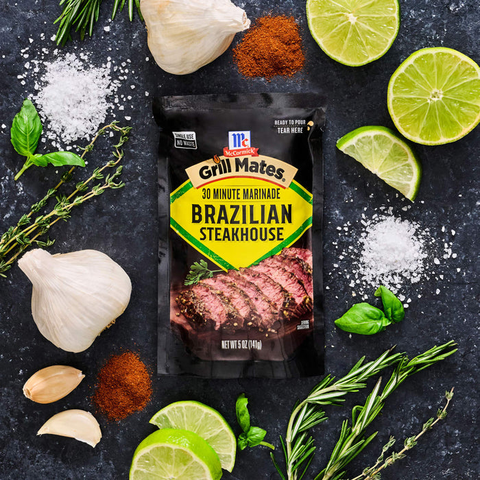 McCormick Grill Mates Brazilian Steakhouse seasoning packet is displayed with fresh ingredients like garlic, lime, and herbs.