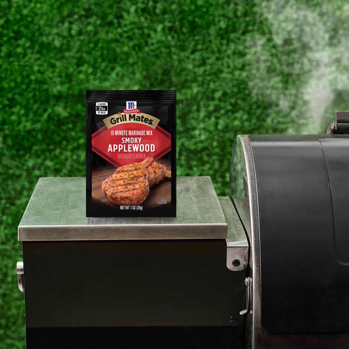 A McCormick Grill Mates Montreal Steak seasoning packet sits on a grill, suggesting a grilling or cooking theme.
