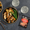 A plate of grilled chicken seasoned with McCormick Grill Mates Smoked Paprika seasoning, served with potatoes and green beans.